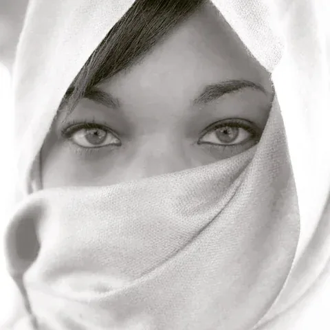 Black and white portrait of eyes above textured fabric