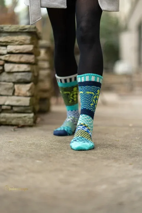 Colorful patterned socks on an outdoor walkway