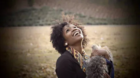 Widescreen portrait of a laughing woman outdoors
