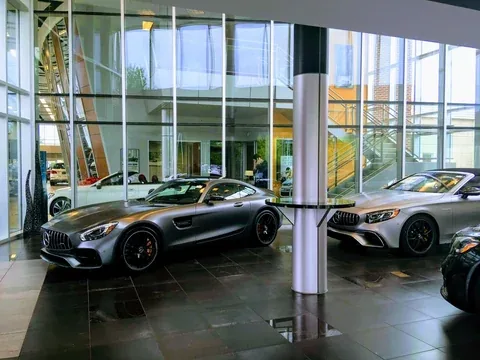 Silver sports cars in a glass-walled showroom