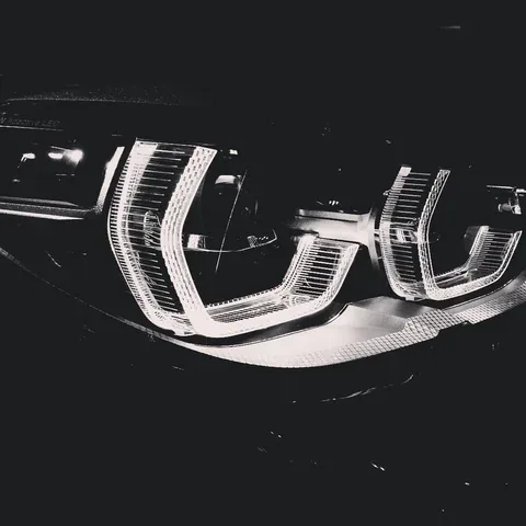 Black and white close-up of car headlights